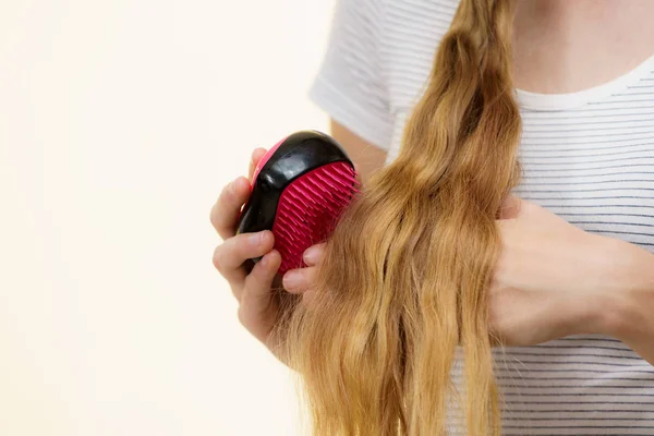 Menina loira escovando seu cabelo longo — Fotografia de Stock