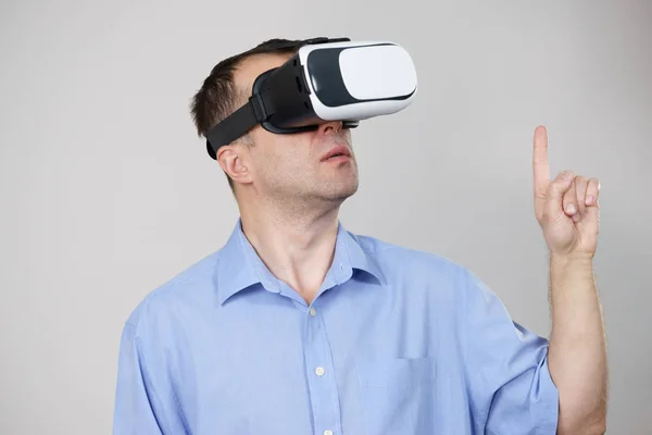 Homem vestindo óculos de realidade virtual em cinza — Fotografia de Stock