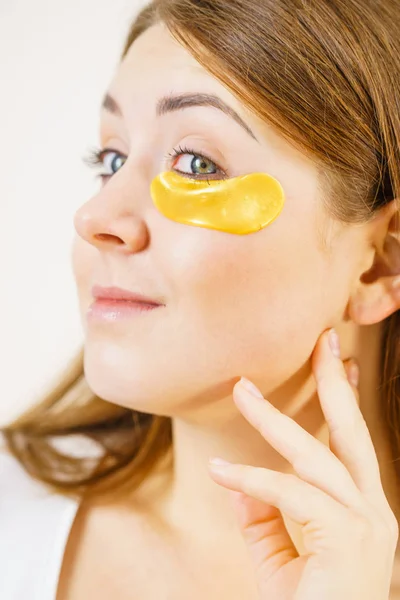 Woman with gold patches under eyes — Stock Photo, Image