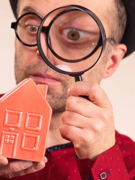 Man magnifying red house — Stock Photo, Image