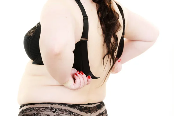 Vrouw terug kijk zetten van haar BH-lingerie. — Stockfoto