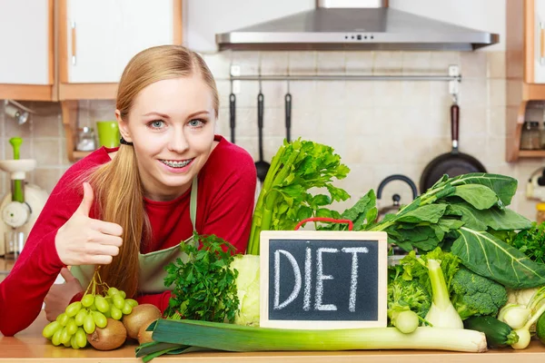 Woman in kitchen having green diet vegetables — Stock Photo, Image