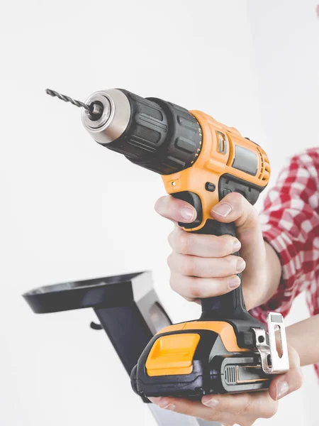 Hand holding yellow drill — Stock Photo, Image