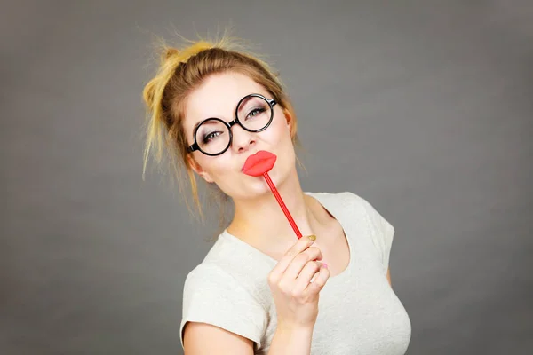 Happy woman holding fake lips on stick — Stock Photo, Image