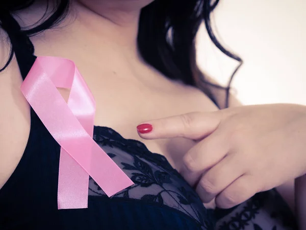 Woman chest in bra, pink cancer ribbon