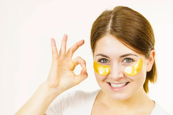 Woman with gold patches under eyes — Stock Photo, Image