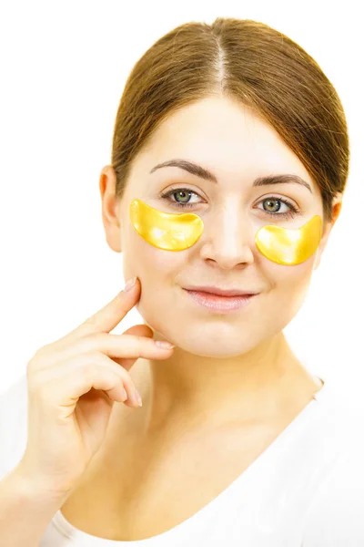 Woman with gold patches under eyes — Stock Photo, Image