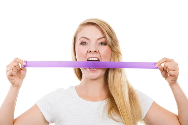 Attractive blonde woman biting tape on mouth. — Stock Photo, Image