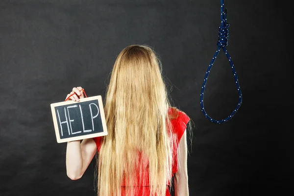 Mulher suicida segurando sinal de ajuda ao lado de corda — Fotografia de Stock