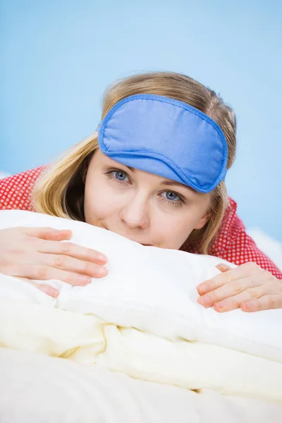 Young woman wearing sleeping eye band in bed — Stock Photo, Image