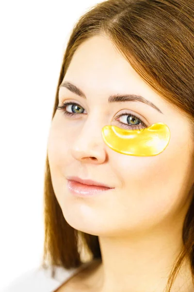 Woman with gold patches under eyes — Stock Photo, Image