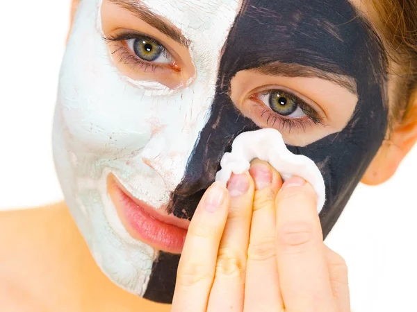 Girl remove black white mud mask from face — Stock Photo, Image