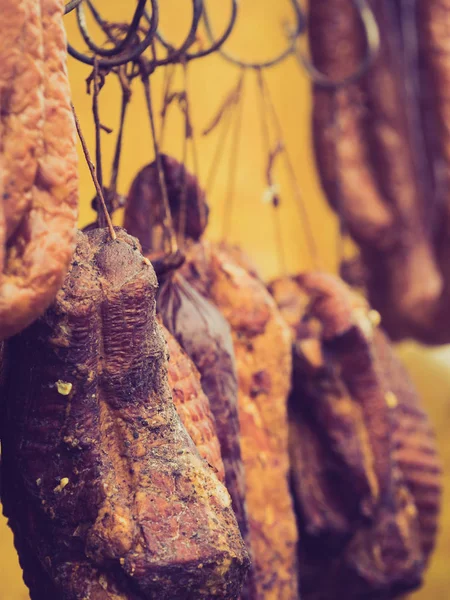 Smoked sausages meat hanging in smokehouse — Stock Photo, Image