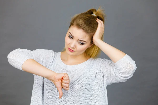 Sad woman showing thumb down gesture — Stock Photo, Image