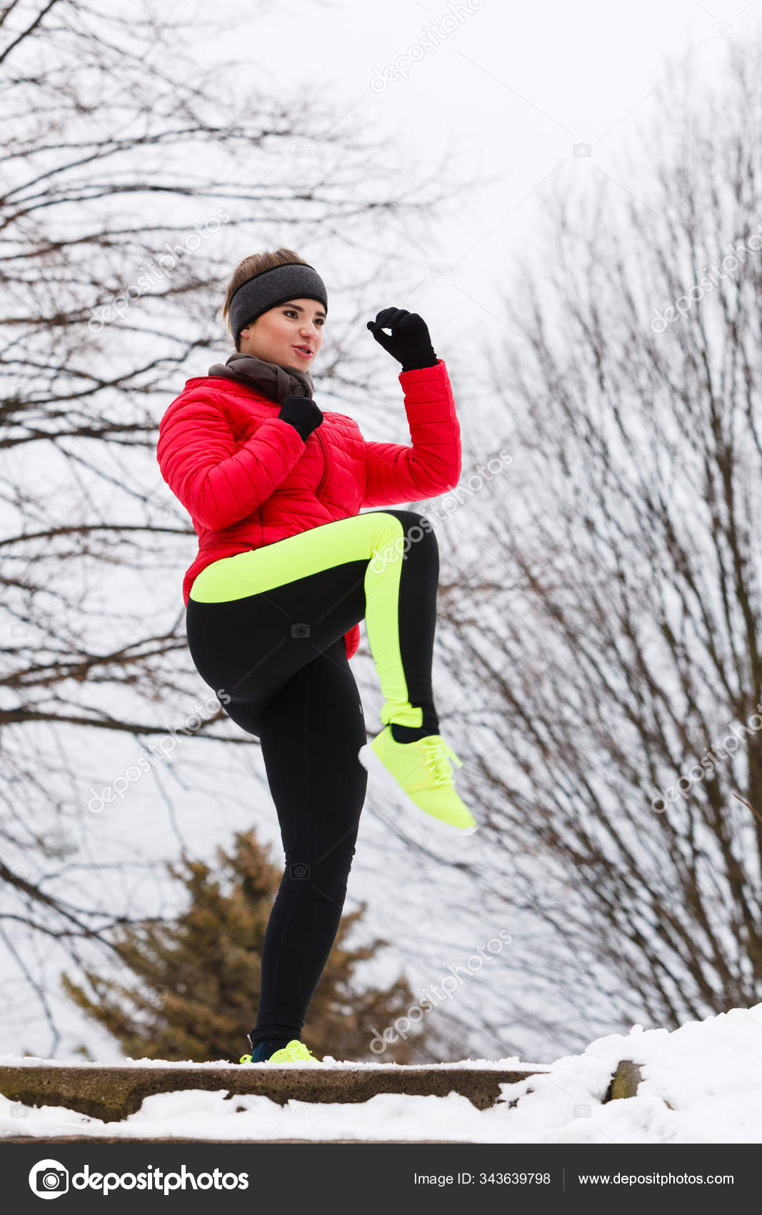 Woman wearing sportswear exercising during winter Stock Photo by ©Voyagerix  343639798