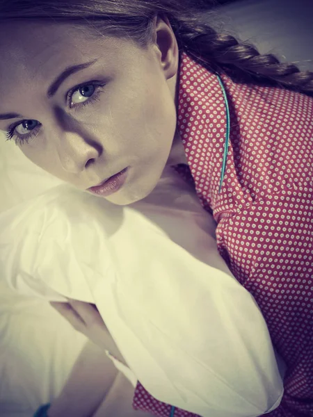 Sad depressed girl in bed gripping pillow — Stock Photo, Image