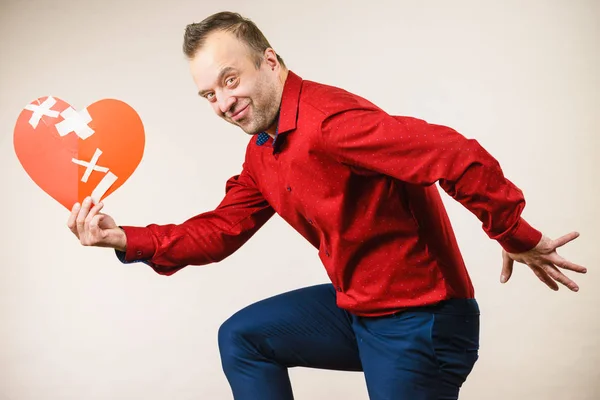 Adult man holding broken heart running — Stock Photo, Image