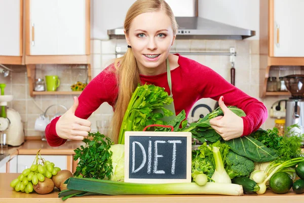 Woman in kitchen having green diet vegetables — Stock Photo, Image