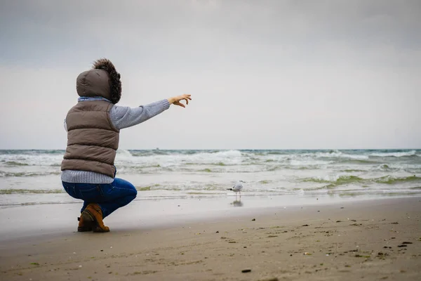 放松和休闲 在海滩上散步的女人女性游客用手指靠近水的地方放置在自然上 秋寒季节 — 图库照片