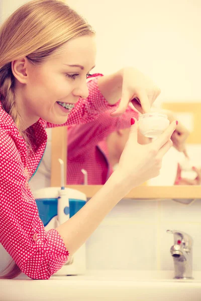 Young Blonde Woman Applying Moisturizing Skin Cream Face Looking Bathroom — Stock Photo, Image