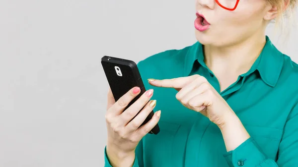 ビジネスの女性の携帯電話を見ている青いシャツを着てソーシャル メディアのチェックを集中 — ストック写真