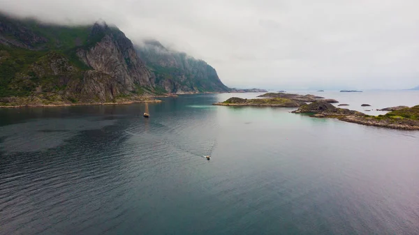 ヨットボートや石の島と海の風景フィヨルドVjestfjord ロフトテン島 ヘニングヴァーバー地域 ノルウェーの水の中にあります 曇り空の日 — ストック写真