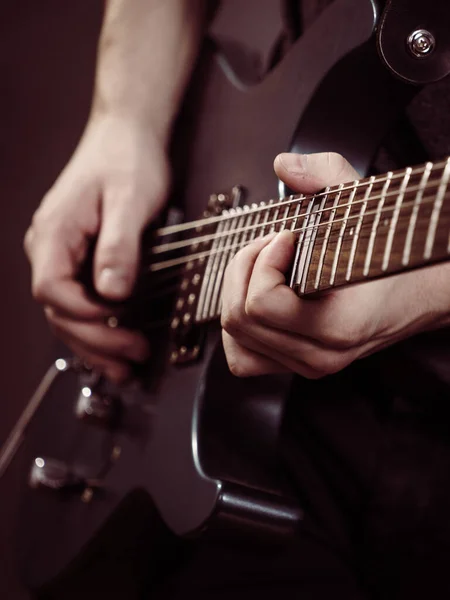 stock image Male hands with electric guitar. Close up, part body adult person is holding instrument and playing. Hobby, music concept