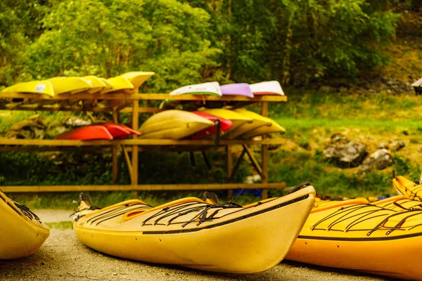 Kayaks on water shore. Rental centre. Travel, holidays and active lifestyle.