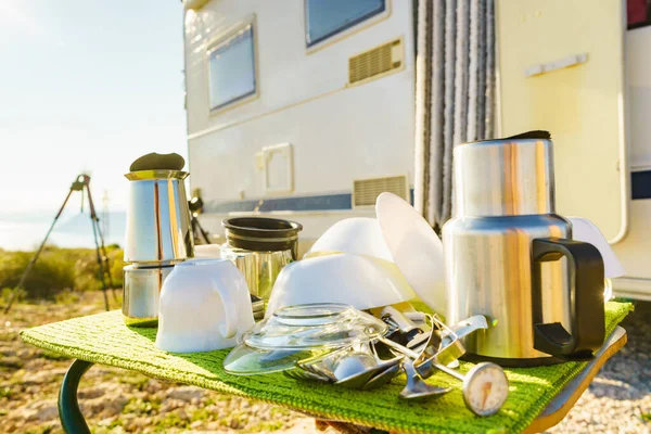 Many clean dishes outdoor on dish drying mat against camper vehicle. Washing up on fresh air. Camping on nature dishwashing outside. Longing for an rv dishwasher. Stock Image Everypixel