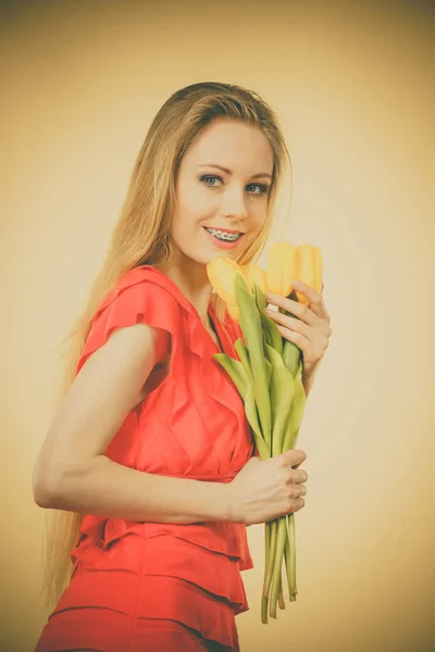 International women day, eight march. Beautiful portrait of pretty woman blonde hair with yellow tulips, fashion make up, elegant dress. Mothers day.