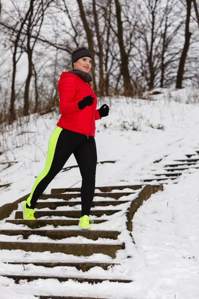 Woman wearing sportswear exercising during winter Stock Photo by ©Voyagerix  343639798