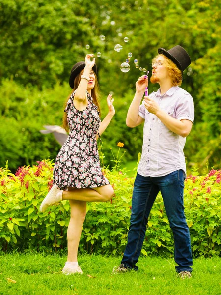 Happy Funny Hipster Couple Playing Together Blowing Soap Bubbles Outdoor — Stock Photo, Image