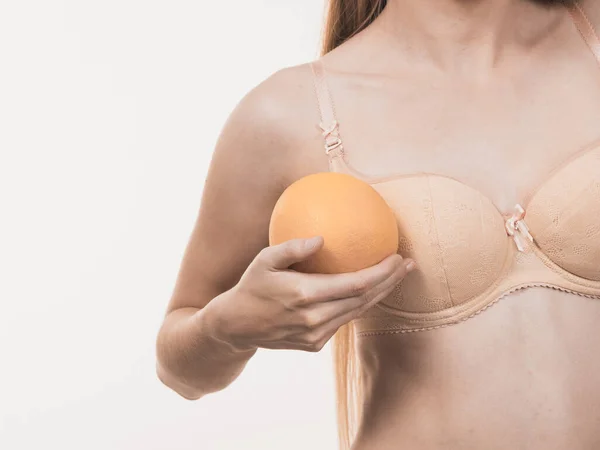 大きなグレープフルーツを持つブラジャーを身に着けているスリム女性の小さなおっぱい 乳房拡大サイズ補正の概念 — ストック写真