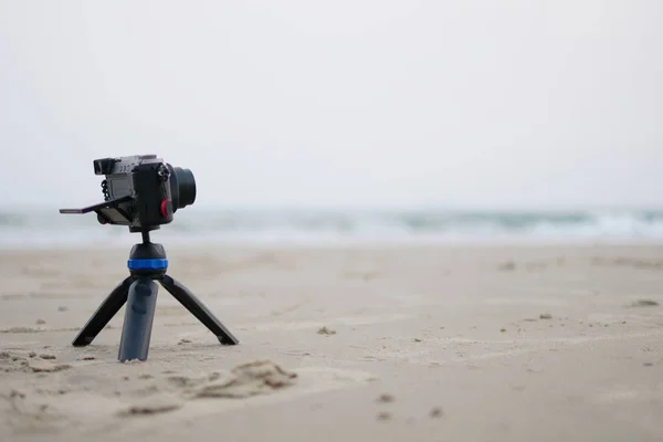 Small camera on stand Take a photo of the sea in the summer vacation concept