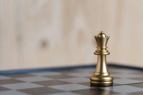 The gold queen chess set on board is located. Select focus shallow depth of field and blurred background. Concept work