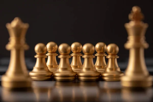 gold queen is the leader of the chess in the game on board.