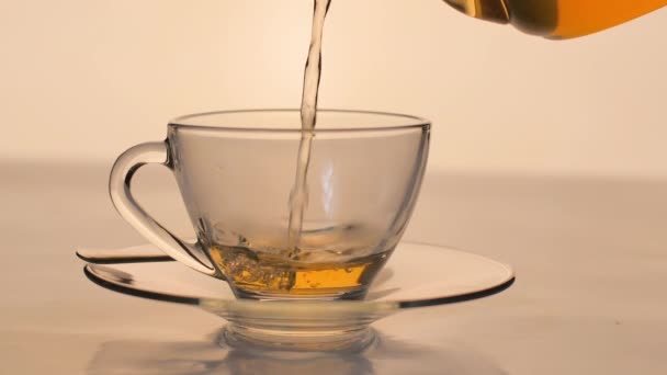 Cámara Lenta Close Tea Vertiendo Vaso Transparente Sobre Mesa — Vídeos de Stock