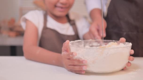 这个亚洲小女孩和她的母亲一起在碗里搅拌面粉 做了一家自制的面包店 — 图库视频影像