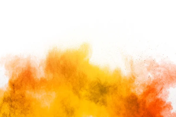 Abstract yellow orange powder explosion on white background. Freeze motion of yellow orange dust particles splash.