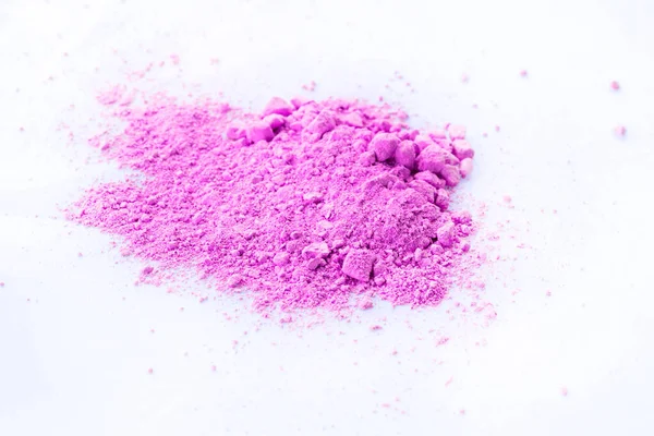 Pile of pink powder isolated on white background.