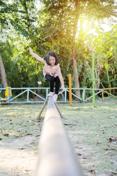 She is practicing balance on the metal walkway. — Stock Photo, Image
