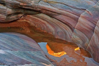 Landscape of a slot canyon with pools of standing water and reflections, Valley of Fire State Park, Nevada, USA