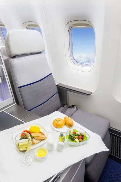 Tray with delicious food on the plane, business class travel. — Stock Photo, Image