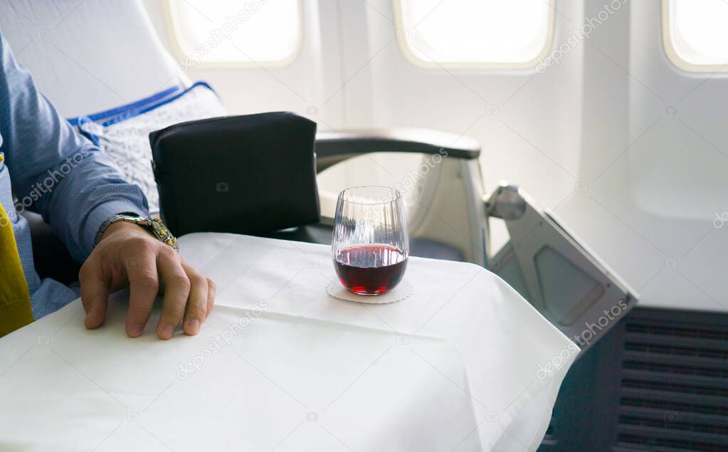 glass of wine inside airplane cabine