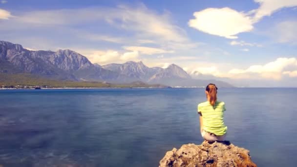 Mujer joven meditando en la costa del mar en la playa — Vídeo de stock