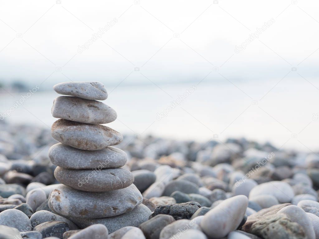 Pyramid of smooth stones on the beach