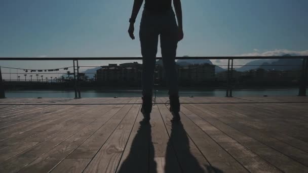 Young woman in roller skates near the river — Stock Video