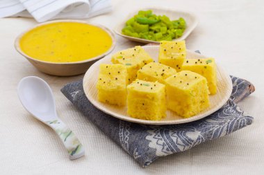 Indian Traditional Street Food Khaman Dhokla Served With Chutney & Chilli clipart