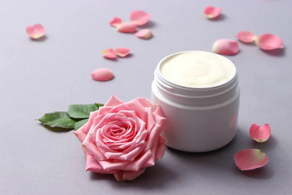 a care cream in a jar on a pastel background with beautiful roses. anti-aging cream. Cream for skin care. for hands. for face. cosmetics for care.