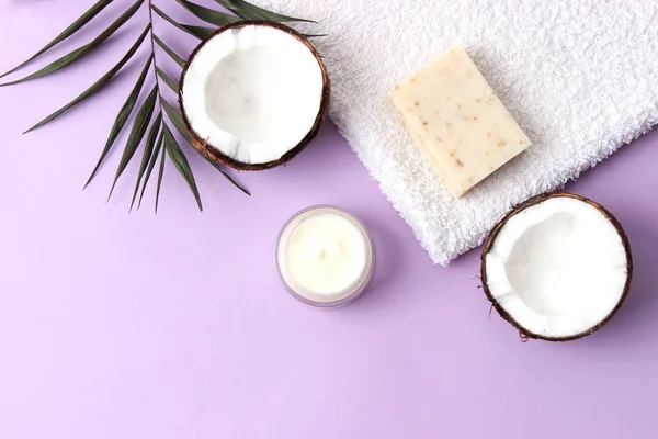 Cosmetic natural skin care products from coconut. coconut and cosmetic cream on a colored background. minimalism, the top. flatlay